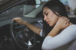 Woman in a car suffering from injury