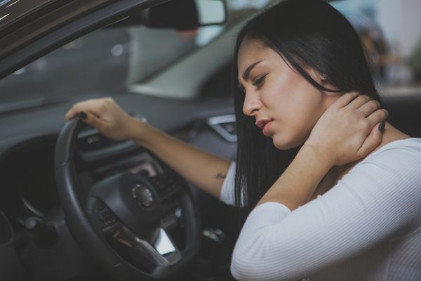 Woman in a car suffering from injury