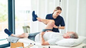 Physiotherapy doctor, senior patient and leg surgery, physical therapy and orthopedic healing