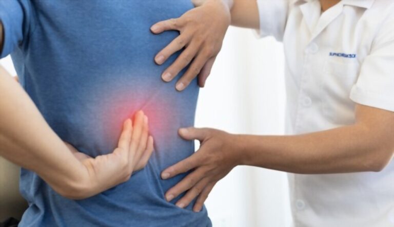 Chiropractor Diagnosing Patients Back Pain